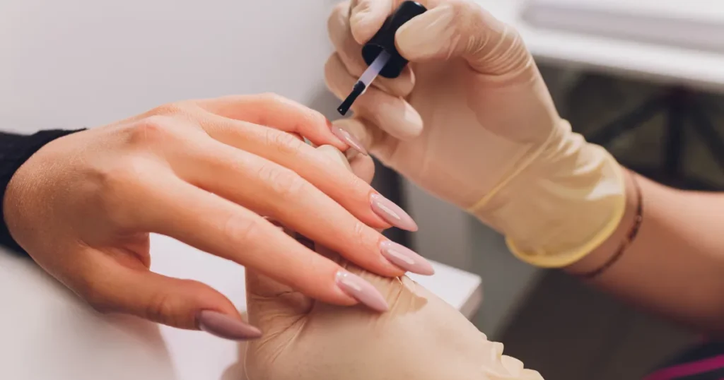 Professional nail technician providing nail polish change services in Union, KY